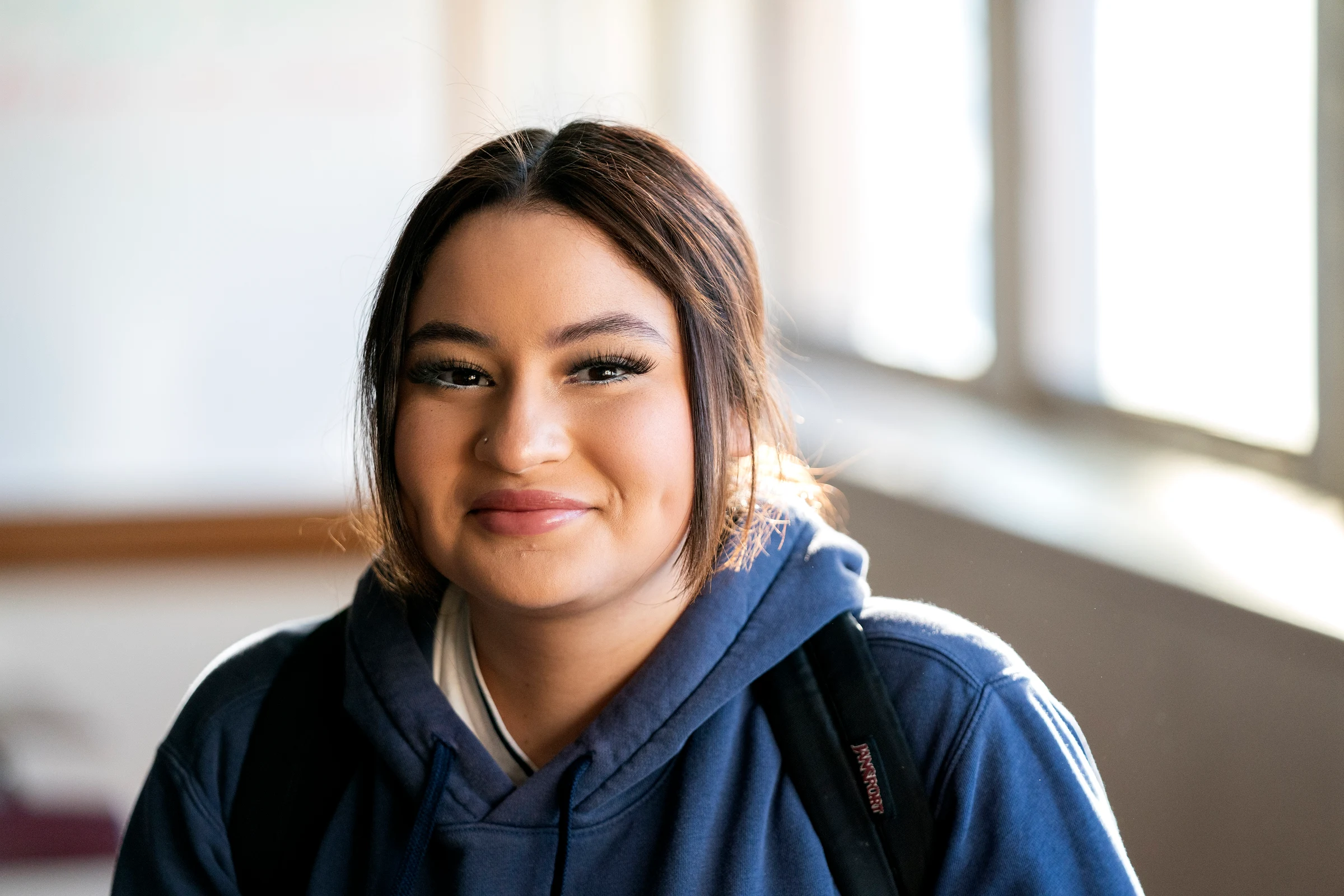 An Elevate USA student smiling in a classroom